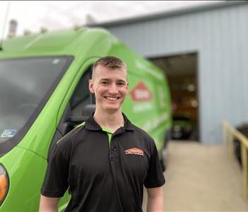 Male SERVPRO of Charlottesville standing next to our service van.