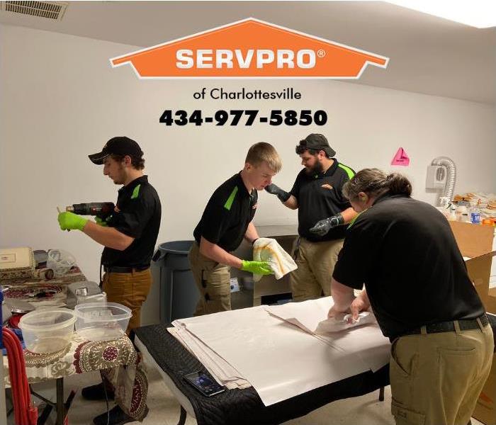 SERVPRO of Charlottesville fire restoration technicians are busy cleaning fire residue from household items damaged by smoke 