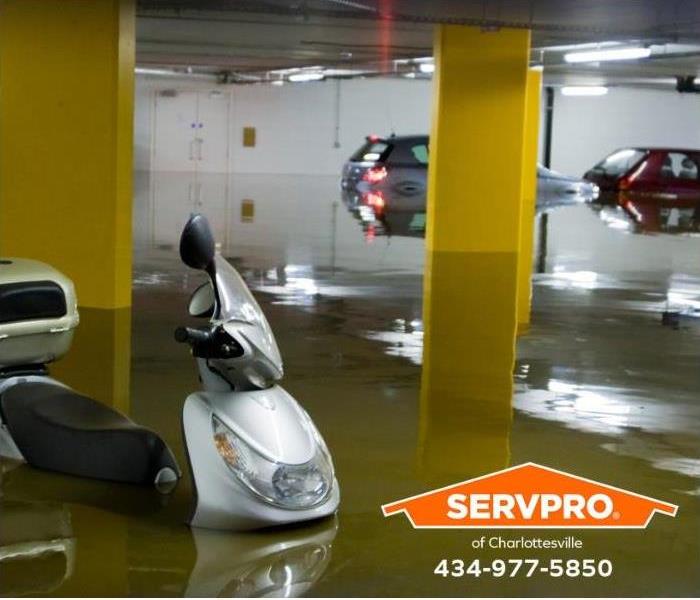 Water floods a parking garage in a commercial building.